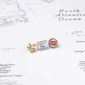 May include: Three metal map pins with custom logos. One is a gold airplane shape with "Logo" text, a silver square with "Your Company" text, and a copper-colored round pin with "Your Logo" text.