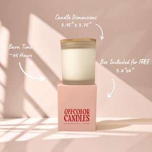 May include: A candle in a frosted glass jar with a wooden lid, sitting on a pink box. The candle dimensions are 3.15" x 3.75". The box is 3.4" x 4". The text on the box reads "OFFCOLOR CANDLES". The burn time is approximately 45 hours.