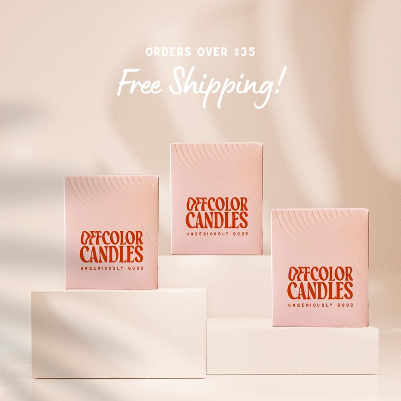 May include: Three pink Offcolor Candles boxes with a wavy design on the front. The boxes have the words "OFFCOLOR CANDLES" in a reddish-orange color, with "UNSERIOUSLY GOOD" below. The background is a light peach color.