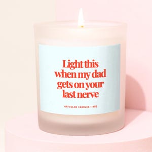 May include: A white frosted glass candle with a light blue label that reads "Light this when my dad gets on your last nerve." The label also includes the text "Offcolor Candles | 8 oz."