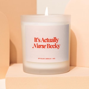 May include: A white frosted glass candle with a red label that reads "It's Actually Nurse Becky" and "Offcolor Candles | 8oz".