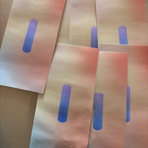 May include: Several rectangular cards with a gradient of pink, peach, and beige. Each card features a vertical blue rectangle. The cards are arranged in a slightly overlapping pattern, creating a visually appealing display.