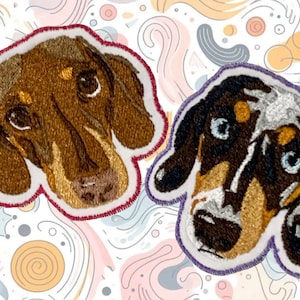 May include: Two embroidered dachshund dog patches. The first patch is brown with a white patch on the chest and has a red stitched border. The second patch is black and white with a purple stitched border.