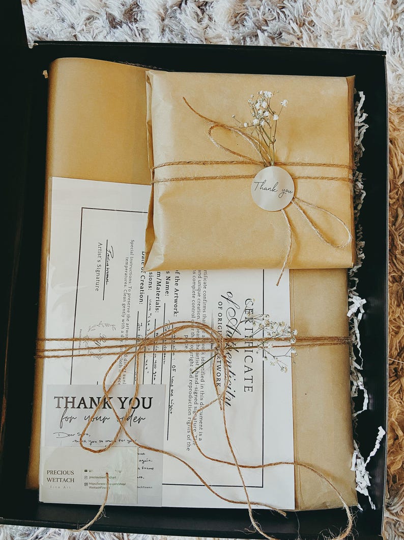 May include: A gift box with brown paper wrapping, tied with twine, and adorned with sprigs of white flowers. The box contains a certificate of authenticity and a thank you card. The text "Thank You for your order" is visible.