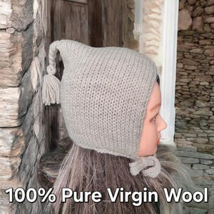 May include: A gray knitted hat with a long tassel. The hat is made of 100% pure virgin wool.