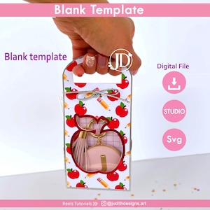 May include: A white gift box with a handle, decorated with red apples and pencils. The box has an apple-shaped cutout revealing a keychain. Text on the box reads "Blank Template" and "Digital File".