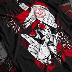 May include: Black t-shirt with a white and red illustration of a vampire with a cross necklace and a pentagram symbol on his forehead. The vampire is wearing a red hat and sunglasses. The background is black with red and white accents.