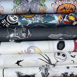 May include: A stack of fabric rolls featuring designs from "The Nightmare Before Christmas." The fabrics display characters like Jack Skellington, Sally, and Zero, along with pumpkins and bats. Colors include black, white, teal, and orange.