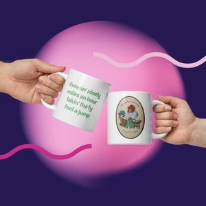 May include: Two white ceramic mugs with different designs. One mug has green text that reads "Runnin' ninety miles an hour takin' thirty feet a jump". The other mug has a cartoon illustration of a bear wearing pajamas and a red hat sitting on a chair.