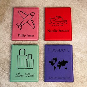 May include: Four passport holders with different designs and names. The first is pink with an airplane and the name Philip James. The second is red with a boat and the name Natalie Stewart. The third is green with suitcases and the name Luna Reed. The fourth is purple with a world map and the name Dylan Ramirez.