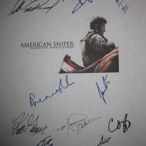 May include: A white sheet of paper with multiple blue signatures. The signatures are from the cast and crew of the movie "American Sniper: The Most Lethal Sniper in U.S. History".