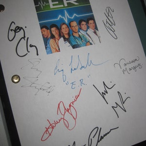 May include: A white sheet of paper with multiple signatures from the cast of the TV show "ER". The signatures include:  "G. Clooney", "Noah Wyle", "Eriq La Salle", "Anthony Edwards", "Laura Innes", "Alex Kingston", "Sherry Stringfield", "Ellen Pompeo", "M.M.", "Vanessa Marquez", and "E.R."