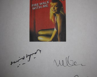 May include: A white sheet of paper with black and blue signatures. The signatures include "Ray Wise", "David Lynch", "M Weller", "Mark Frost", and "Sherilyn Fenn". The paper also has a small, red, white, and black poster for the show "Twin Peaks" with the text "Fire Walk With Me".