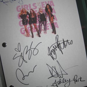 May include: White sheet of paper with black signatures from the band Girls Aloud. The signatures include Cheryl, Sarah, Nadine, Kimberley, and Nicola. The band's name is printed in pink letters on the paper.