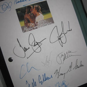 May include: A white paper with multiple signatures in black and blue ink. A small image from the television show "Dr. Quinn, Medicine Woman" is in the center. The signatures appear to be autographs.