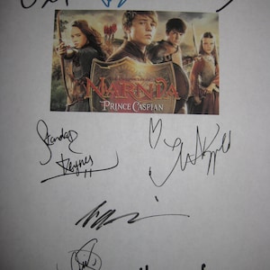May include: A promotional image for "The Chronicles of Narnia: Prince Caspian" featuring a movie poster with cast members and the film's title. The image is surrounded by multiple signatures in black ink, likely autographs from the cast or crew.