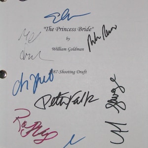 May include: A white page with multiple signatures in black, blue, and red ink. The text "The Princess Bride" and "William Goldman" are also visible. The page has two ring binder holes.