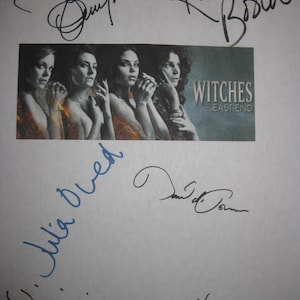 May include: A white sheet of paper with multiple signatures in black and blue ink. A small image features four women and the text "Witches of East End".