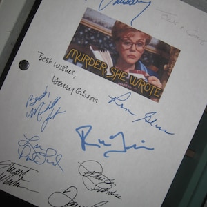May include: A white sheet of paper with a photo of Angela Lansbury as Jessica Fletcher from the TV show "Murder, She Wrote". The paper is signed by Angela Lansbury, along with other cast members and crew, including Jerry Orbach, Ron Silver, and  the show's creator,  Peter S. Fischer.