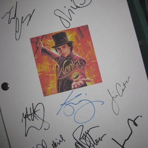 May include: A white sheet of paper with multiple signatures in black ink. The signatures include "Willy Wonka", "Johnny Depp", "Tim Burton", and others. A photo of Johnny Depp as Willy Wonka from the movie "Charlie and the Chocolate Factory" is in the center of the page.