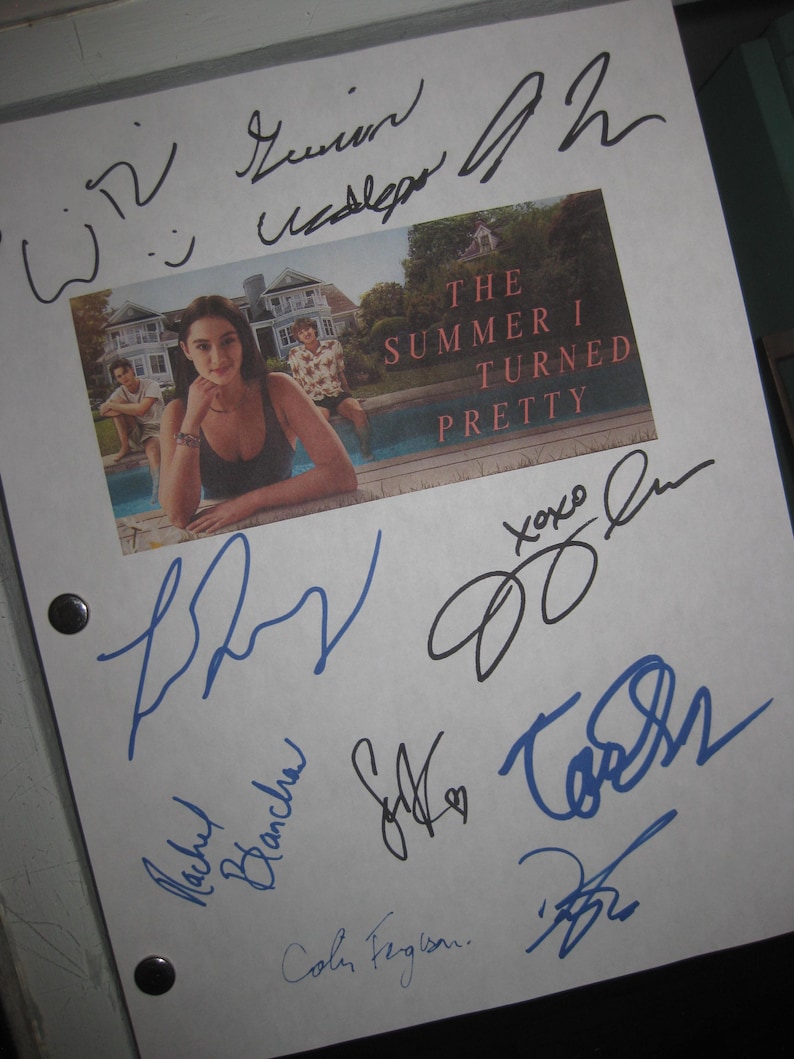 May include: A white paper with a color image from "The Summer I Turned Pretty" and multiple signatures in blue and black ink. The image shows a woman in a swimsuit by a pool. The title is in red.