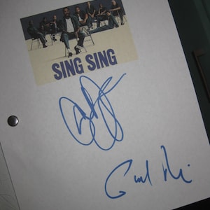 May include: A white script with the words "Sing Sing" printed in blue. The script is signed by a person with the name "C. Wall Niu" in blue ink.