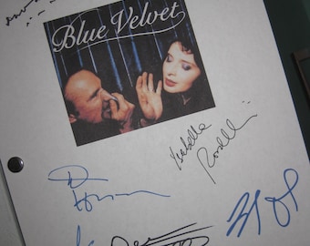 May include: A white sheet of paper with signatures from the cast of the movie "Blue Velvet". The signatures include Kyle MacLachlan, Isabella Rossellini, and Dennis Hopper. The movie poster for "Blue Velvet" is in the background.