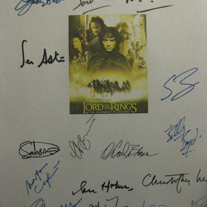 May include: A white sheet of paper with multiple signatures from the cast of the Lord of the Rings: The Fellowship of the Ring movie. The signatures include Sean Astin, Peter Jackson, Ian McKellen, and others. The image also includes a movie poster for the film.