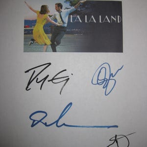May include: A white sheet of paper with multiple signatures and a small image from the movie "La La Land." The image shows a man and woman dancing. The signatures are in black and blue ink.
