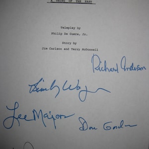 May include: A white sheet of paper with the title "THE BIONIC WOMAN" and the episode title "A THING OF THE PAST" printed in black. Several signatures in blue ink are present, including "Richard Anderson" and "Lee Majors".