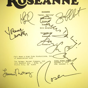 May include: A yellow paper with the title "ROSEANNE" in bold black letters. The paper includes handwritten signatures and text, including "Satan, Darling" and "FINAL MIMEO DRAFT October 2, 1996".