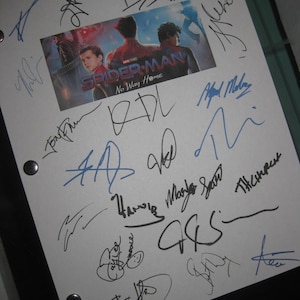 May include: A white sheet with multiple signatures in black and blue ink. A small image from the movie "Spider-Man: No Way Home" is centered on the sheet. The signatures appear to be autographs.