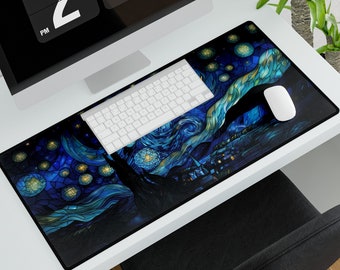May include: A long rectangular desk mat featuring a starry night design in shades of blue, yellow, and black. A white keyboard and mouse sit on the mat, with a computer monitor and a plant in the background.