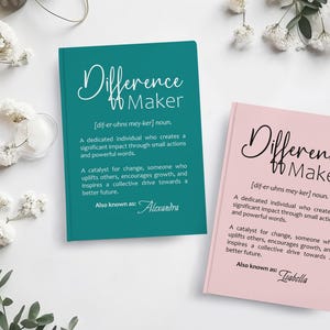 May include: Two teal and pink notebooks with the words "Difference Maker" and the definition of the word. The teal notebook says "Also known as: Alexandra" and the pink notebook says "Also known as: Isabella".