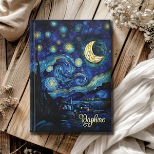 May include: A blue and yellow stained glass notebook cover with a swirling night sky, a crescent moon, and stars. The cover has the name "Daphne" written in gold script.
