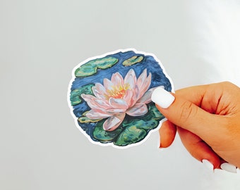 May include: A sticker featuring a pink water lily with green leaves, surrounded by blue water. The sticker is on a white background.