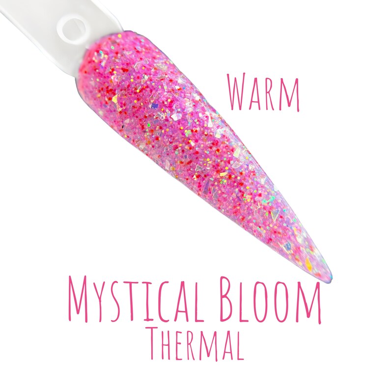 May include: A nail swatch with a pink glitter design. The text "WARM" is written in pink script. The text "MYSTICAL BLOOM THERMAL" is written in pink script below the nail swatch.
