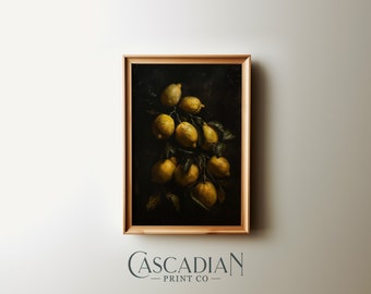 May include: A framed art print featuring a still life of lemons. The lemons are a vibrant yellow, clustered on a branch with green leaves, set against a dark background. The frame is a light brown color. The text "Cascadian Print Co" is at the bottom.