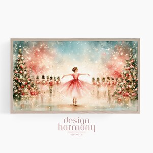 May include: A framed horizontal wall art print featuring a watercolour illustration of a ballerina in a red dress dancing between two decorated Christmas trees, surrounded by a line of nutcracker figures and falling snow, with the text design harmony studio co.