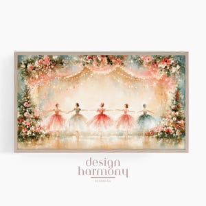 May include: A framed horizontal wall art print featuring five dancers in colourful tutus holding hands on a stage. The scene is decorated with lush floral arrangements and string lights. The text design harmony studio co. appears below.