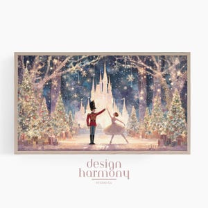 May include: A framed print depicting a winter scene with a nutcracker and a ballerina dancing in front of a castle. The artwork has a soft, watercolour style with Christmas trees, snowflakes, and a warm colour palette. The text "design harmony STUDIO Co." is at the bottom.