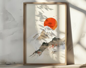 May include: A framed print of a watercolor painting depicting a snow-capped mountain with a large red sun behind it. The mountain is surrounded by a light blue sky and a few small red birds are flying in the sky.
