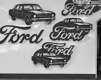 May include: A white wall with three black Ford logos and three black silhouettes of Ford cars. The logos are in a stylised script font. The cars are all facing the right side of the image.