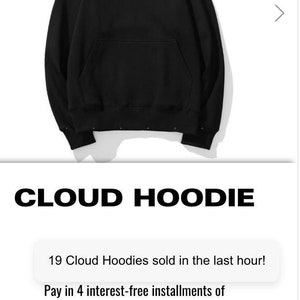 Puede incluir: Sudadera con capucha negra con un logotipo de estrella blanca en la parte delantera. La sudadera tiene una capucha con cordón y un bolsillo canguro. El texto "CLOUD HOODIE" se muestra debajo de la imagen. El texto "19 Cloud Hoodies sold in the last hour!" se muestra en un cuadro blanco. El texto "Pay in 4 interest-free installments of" se muestra debajo del cuadro blanco.