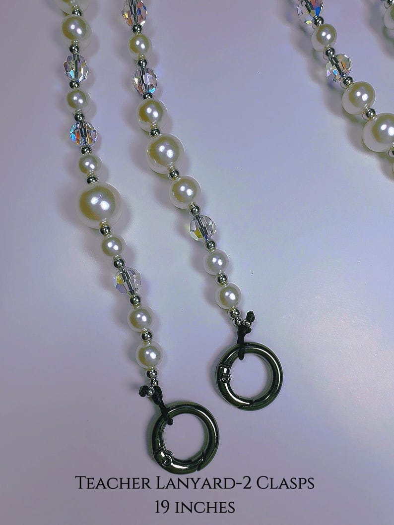 May include: White pearl and crystal beaded lanyard with two silver clasps. TEACHER LANYARD-2 CLASPS 19 INCHES.