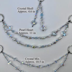 May include: Three decorative beaded chains with silver-tone clasp rings. The top piece is a Crystal Skull design, approx. 4.6 in. The middle is a Pearl Heart design, approx. 11 in. The bottom is a Crystal Mix design, approx. 10.5 in. Length excludes clasp rings.