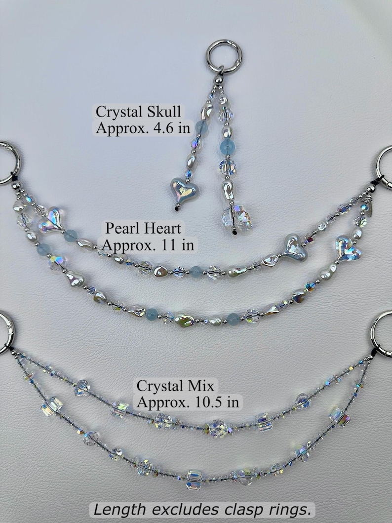 May include: Three decorative beaded chains with silver-tone clasp rings. The top piece is a Crystal Skull design, approx. 4.6 in. The middle is a Pearl Heart design, approx. 11 in. The bottom is a Crystal Mix design, approx. 10.5 in. Length excludes clasp rings.