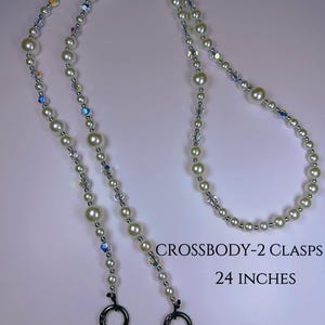May include: A white pearl and crystal beaded chain with two black metal clasps. The chain is 48 inches long and has two 24-inch sections. CROSSBODY-2 CLASPS 24 INCHES OVERALL LENGTH 48 INCHES