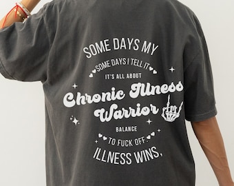 May include: A dark gray t-shirt with a white graphic print that reads "Some days my, some days I tell it, it's all about Chronic Illness Warrior, balance to fuck off, Illness wins."