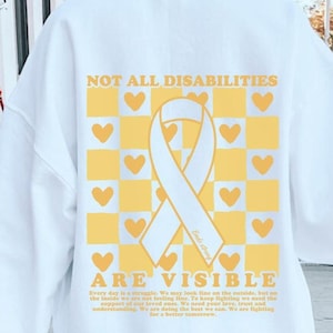 May include: White sweatshirt with a yellow and white checkered pattern and a yellow ribbon with the text "Not all disabilities are visible" printed on the back.